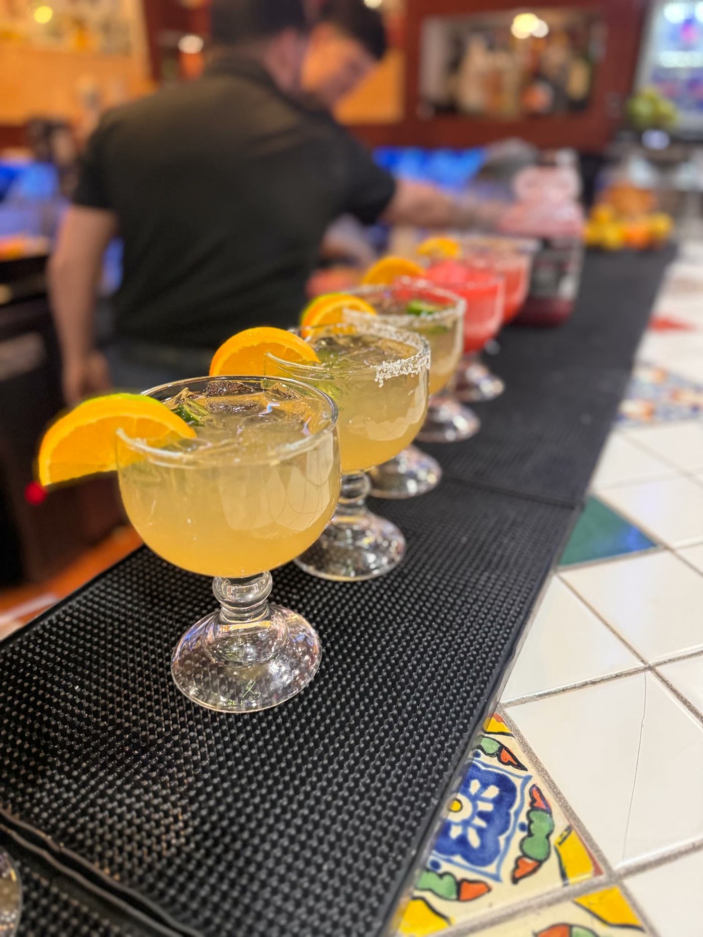 Row of house margaritas lined up on the bar