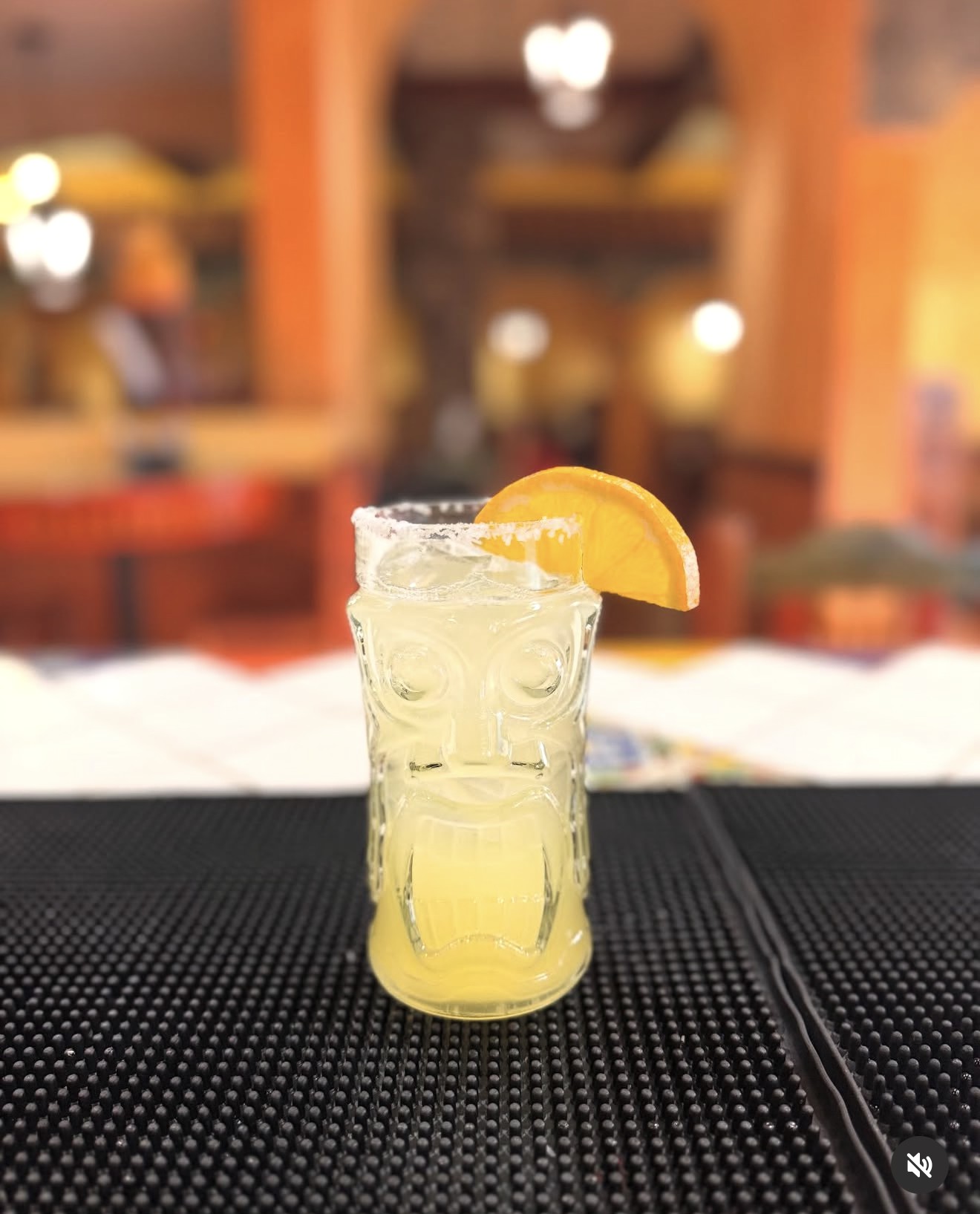 Margarita in a tiki glass with an orange slice